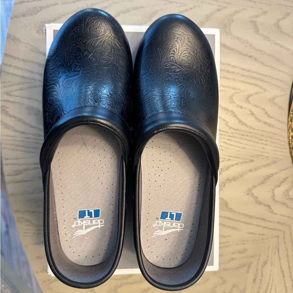 Dansko Black Floral Embossed Clogs